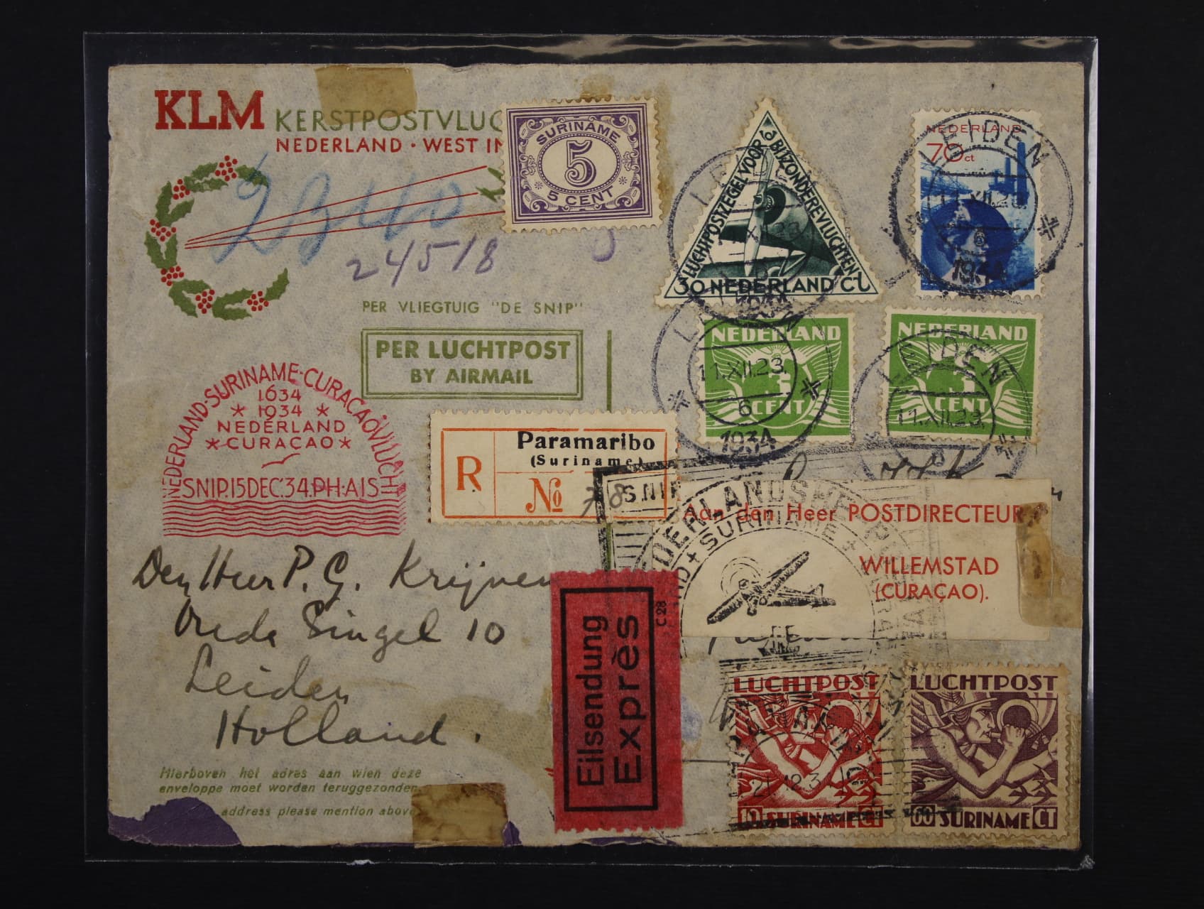 R-celistvost přepr. 1. letem NEDERLAND - SURINAME - CURACAOVLUCHT 15.DEC.1934, frank. pestrou frankaturou s pod. raz. LEIDEN 11.12.34, dofrank. zn. Surinam 10 + 60c s raz. PARAMARIBO, znehodnoc. černý