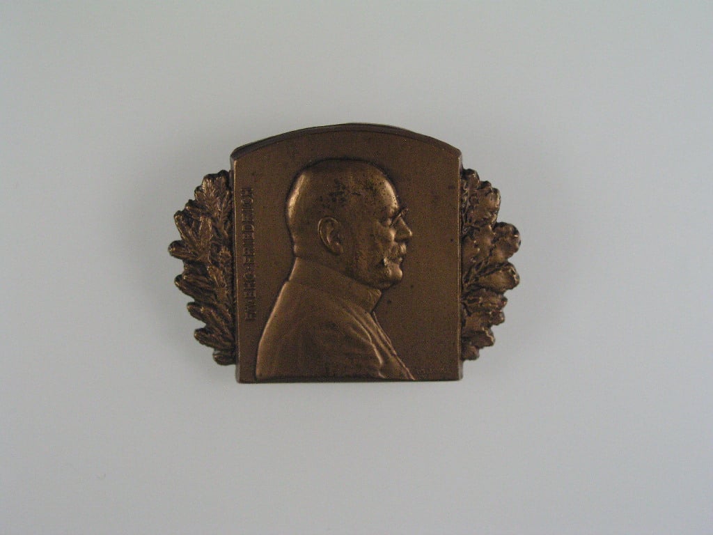 Čepicový odznak FM. EHG. FRIDRICH