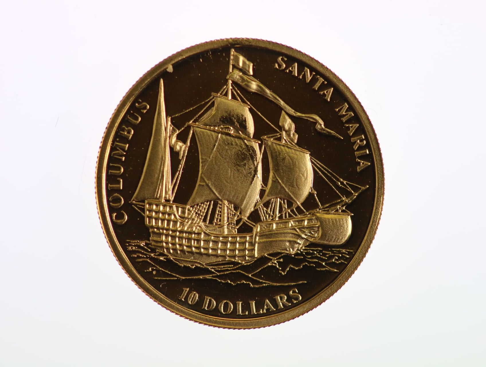 10 Dolar 2006, vlajková loď Kryštofa Kolumba Santa María, Au 0.999, 1,24 g. průměr 13,92 mm